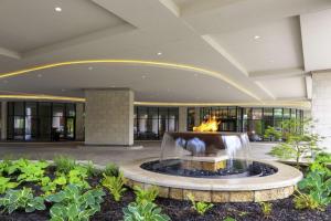 a lobby with a fountain in the middle of a building at Embassy Suites By Hilton Grand Rapids Downtown in Grand Rapids