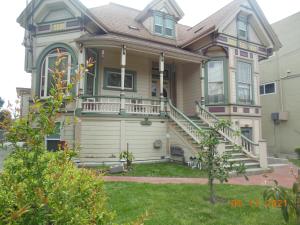 a large house with a porch and a yard at Alameda 3BR unique Victorian Penthouse, AC, 3 blocks to beach & shopping center & 2 free parking spaces in Alameda