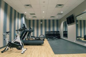 a gym with treadmills and exercise bikes in a room at Hilton Garden Inn Spartanburg in Spartanburg