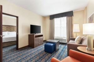 a hotel room with a couch and a television at Homewood Suites By Hilton Harlingen in Harlingen