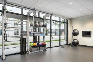 a gym with a lot of windows and a large room at Tru By Hilton Ft Lauderdale Airport in Dania Beach