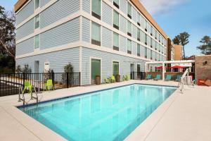 a swimming pool in front of a building at Home2 Suites By Hilton Fernandina Beach on Amelia Island, FL in Fernandina Beach