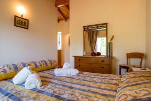 a bedroom with two towels on a bed at 5 bedrooms house with private pool terrace and wifi at Agueda in Aguda