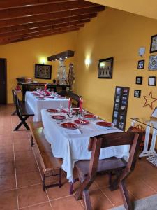 a dining room with a table with white table cloth at 5 bedrooms house with private pool terrace and wifi at Agueda in Aguda
