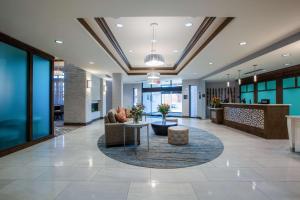 an office lobby with a waiting area and a table at Homewood Suites By Hilton Reston, VA in Reston