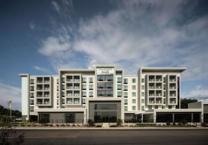 a large white building with a clock on top of it at Homewood Suites By Hilton Jackson Fondren Medical District in Jackson