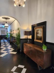 a lobby with a dresser and a picture on the wall at The Macquarie Hobart in Hobart