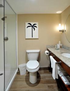 a bathroom with a toilet and a shower and a sink at Hotel Dello Ft Lauderdale Airport, Tapestry Collection by Hilton in Dania Beach