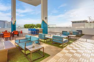 a patio with tables and chairs on a roof at SERENA Hotel Aventura Miami, Tapestry Collection by Hilton in Aventura