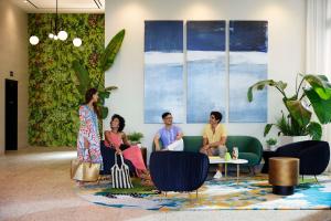 a group of women sitting on a couch in a room at SERENA Hotel Aventura Miami, Tapestry Collection by Hilton in Aventura