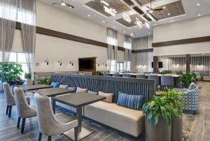 a lobby of a hotel with tables and chairs at Homewood Suites By Hilton Edison Woodbridge, NJ in Edison