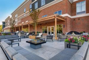 a patio with couches and tables and a building at Homewood Suites By Hilton Edison Woodbridge, NJ in Edison
