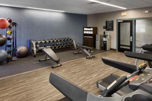 a gym with treadmills and weights in a room at Hampton Inn Newark Airport in Newark
