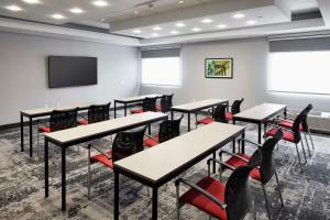a classroom with tables and chairs and a flat screen tv at Hampton Inn Newark Airport in Newark