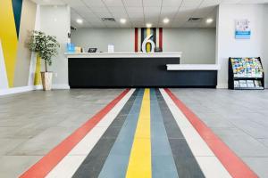 a lobby with a colorful striped floor in a store at Motel 6 Gonzales, LA Baton Rouge Geismar Prairieville I 10 in Gonzales
