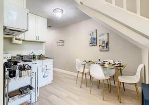 a kitchen and dining room with a table and chairs at Charming Lakeview Retreat in Orlando