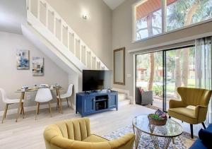 a living room with a staircase and a table and chairs at Charming Lakeview Retreat in Orlando