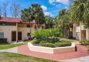 a building with palm trees in front of it at Charming Lakeview Retreat in Orlando