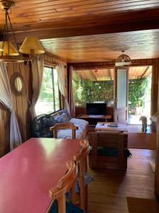 a living room with a couch and a table at Cabaña Pucón in Pucón