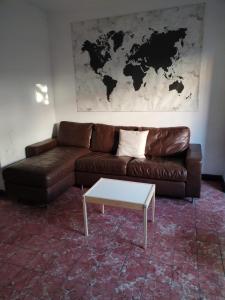 a living room with a leather couch and a coffee table at La Cortesana in Mexico City