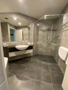 a bathroom with a sink and a shower at Alpine Woodsmoke Apartments in Falls Creek +42 photos