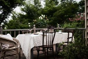a table with a white table cloth on a deck at Luxury Bendigo Stay in Golden Square