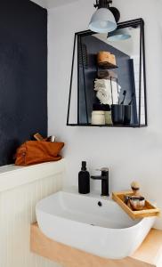 a bathroom with a white sink and a mirror at Mine and Farm, The Inn at Guerneville, CA in Guerneville +34 photos