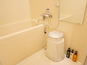 a bathroom with a shower and a trash can at APA Hotel Honhachinohe in Hachinohe