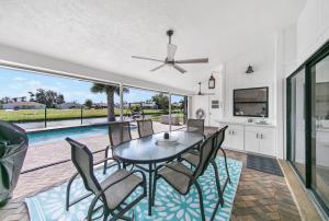 a dining room with a table and chairs and a pool at Waterside Villa Fish Swim Golf Enjoy in Rotonda West