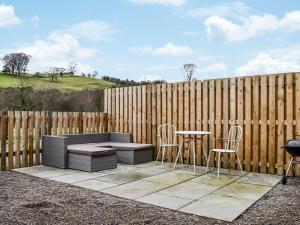 a patio with a table and chairs and a fence at The Old Hemmel-uk44853 in Holton