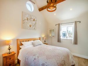 a bedroom with a bed and a window at Bank House Barn in Audlem