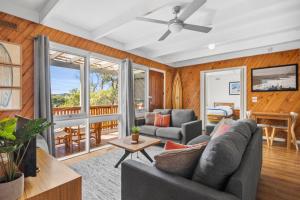 a living room with a couch and a ceiling fan at Torquay Boulevard Beach House in Torquay