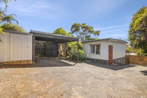 a house with a garage and a fence at Torquay Boulevard Beach House in Torquay