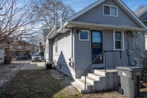 a house with a porch and stairs in front of it at Indy 4-Bedroom Haven: Your Perfect Retreat in Indianapolis