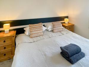 a bedroom with a white bed with two night stands at Anglers Rest in Stoke Gabriel