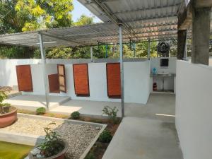 an outdoor room with a row of doors on a wall at PHU QUOC BACKPACKER in Phu Quoc