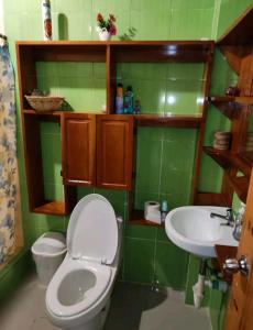 a bathroom with a toilet and a sink at Casa Campestre in Bocas del Toro