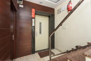 an elevator in a building with a door and stairs at OYO Flagship Hotel Shri Vilas in Bhopal