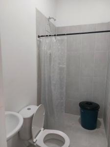 a bathroom with a toilet and a sink and a shower at Cabaña Maríamar2 in Puerto Escondido