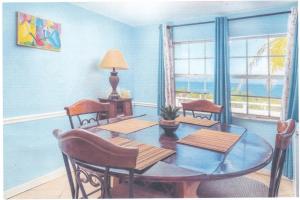 a dining room with a table and chairs and the ocean at John’s Place in Grand Turk