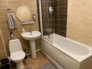 a bathroom with a sink and a toilet and a bath tub at Aston Apartment 4 -Secure Parking in Birmingham