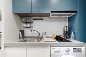a kitchen with a sink and a dishwasher at Urbanstay Sokcho Beach AB in Sokcho