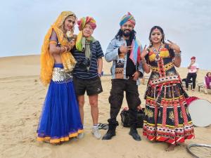a group of people standing on the beach at Blue Eye Hostel in Jaisalmer