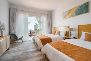 a hotel room with two beds and a balcony at Orestay Garden Hạ Long in Ha Long +142 photos