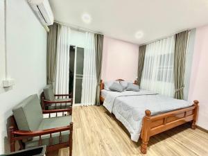 a bedroom with a large bed and two chairs at Number9 Bangkoknoi BKK in Bangkok