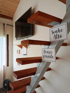 a staircase in a house with signs on it at Vista Verde Tiradentes in Tiradentes +38 photos
