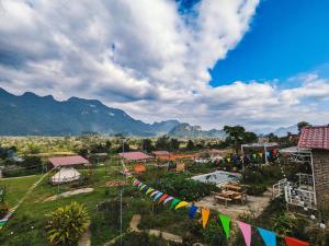 a group of flags in a field with mountains in the background at WIND HILL HOMESTAY HÀ GIANG in Làng Me