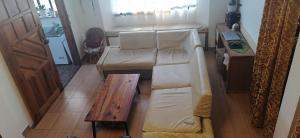 a living room with a couch and a table at Mavy's Maligcong Homestay in Bontoc
