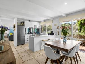 a kitchen and dining room with a table and chairs at Quarterdeck in Portsea