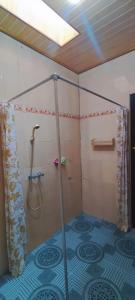 a bathroom with a shower with a shower curtain at green view downtown in Ubud